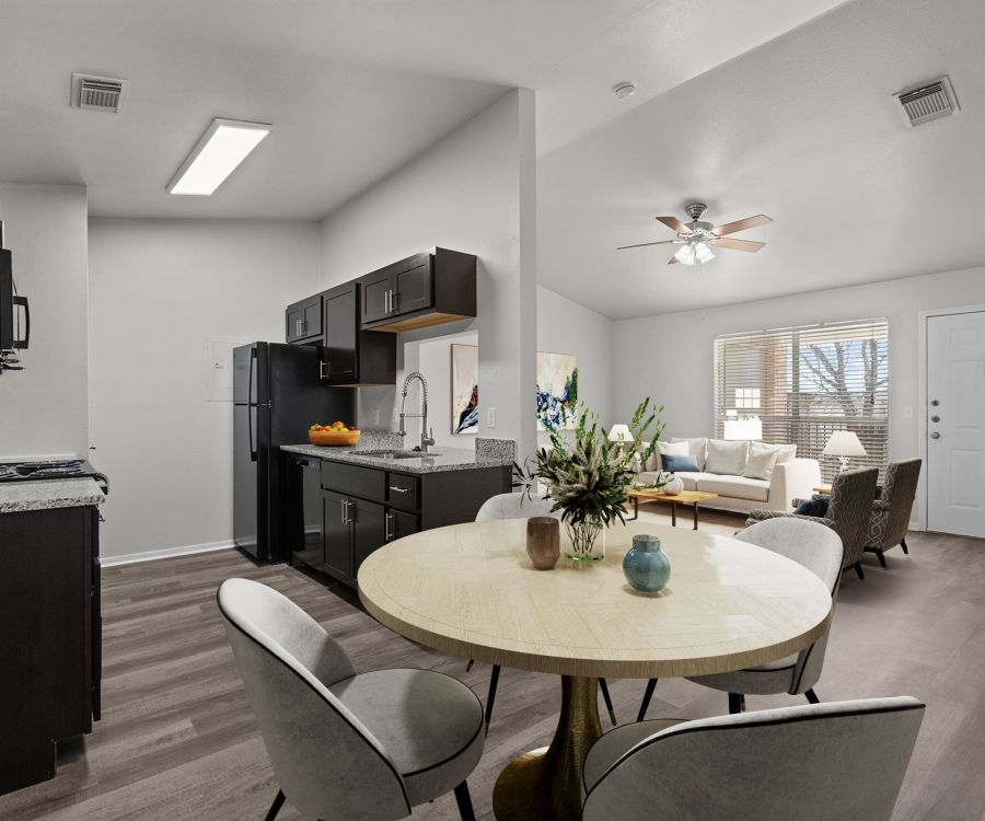 Encino Park apartments home interior with open floor plan showing kitchen, dining area and living room