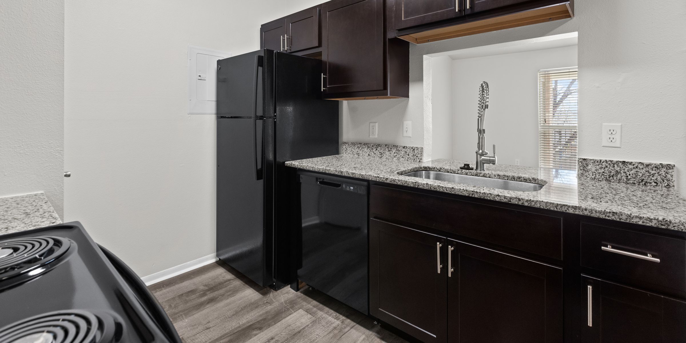 Luxury apartment living room with large windows, wood style floors and contemporary furniture at The Civic at Frisco Square