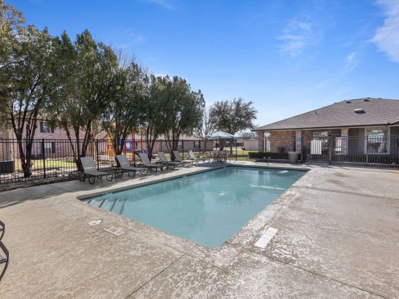 Encino Park apartments community swimming pool surrounded by clubhouse and lounge area